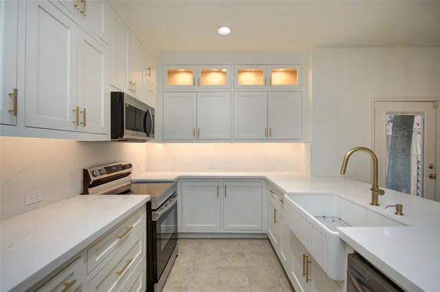 a kitchen with a sink stove and cabinets