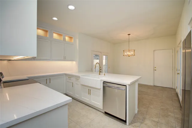 a kitchen with a sink and a refrigerator