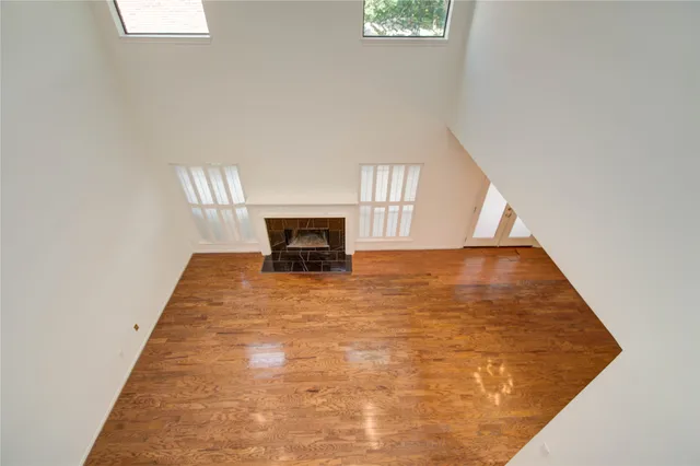 view of an empty room with wooden floor and a window
