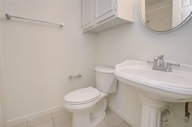 a white toilet sitting next to a bathroom sink