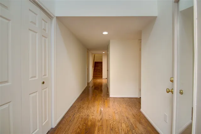 a view of hallway with wooden floor
