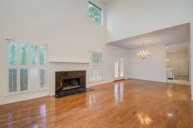 a view of an empty room with window and fireplace