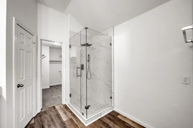 a bathroom with a glass shower door
