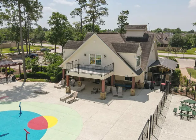 an aerial view of a house with swimming pool and furniture
