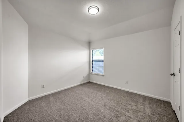 a view of a backyard with wooden fence