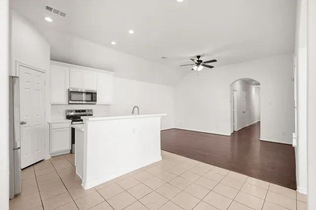 a view of a kitchen with a sink dishwasher and a refrigerator