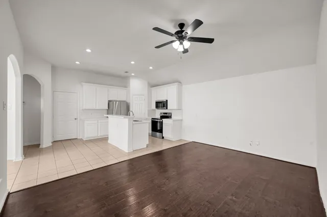 a view of a kitchen with a sink and refrigerator