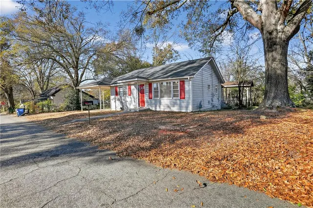 a view of a house with a yard and wooden fence