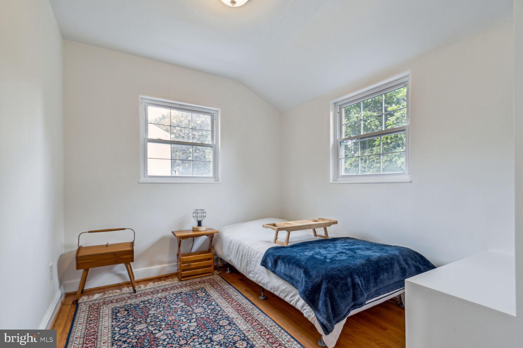 8504 Grubb Road Chevy Chase, MD 20815 - Photo 12 of 29 a bedroom with a bed window and table