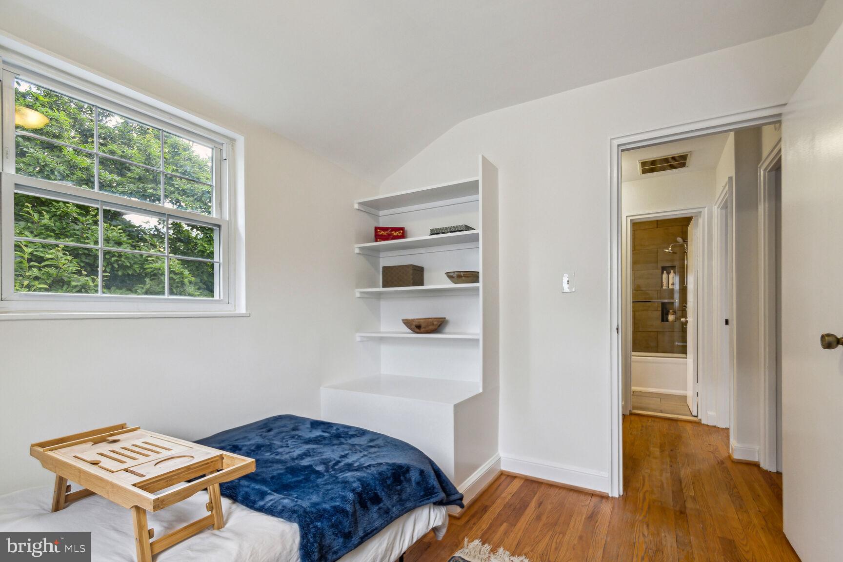 8504 Grubb Road Chevy Chase, MD 20815 - Photo 13 of 29 a bedroom with a bed and wooden floor
