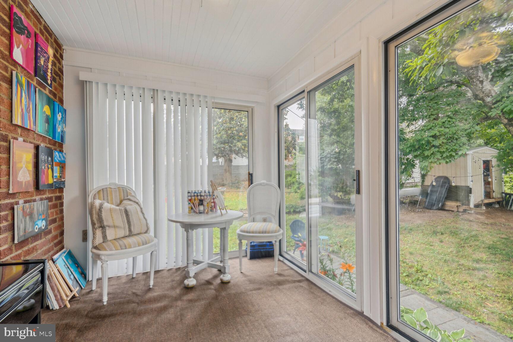 8504 Grubb Road Chevy Chase, MD 20815 - Photo 19 of 29 a room with furniture and a floor to ceiling window