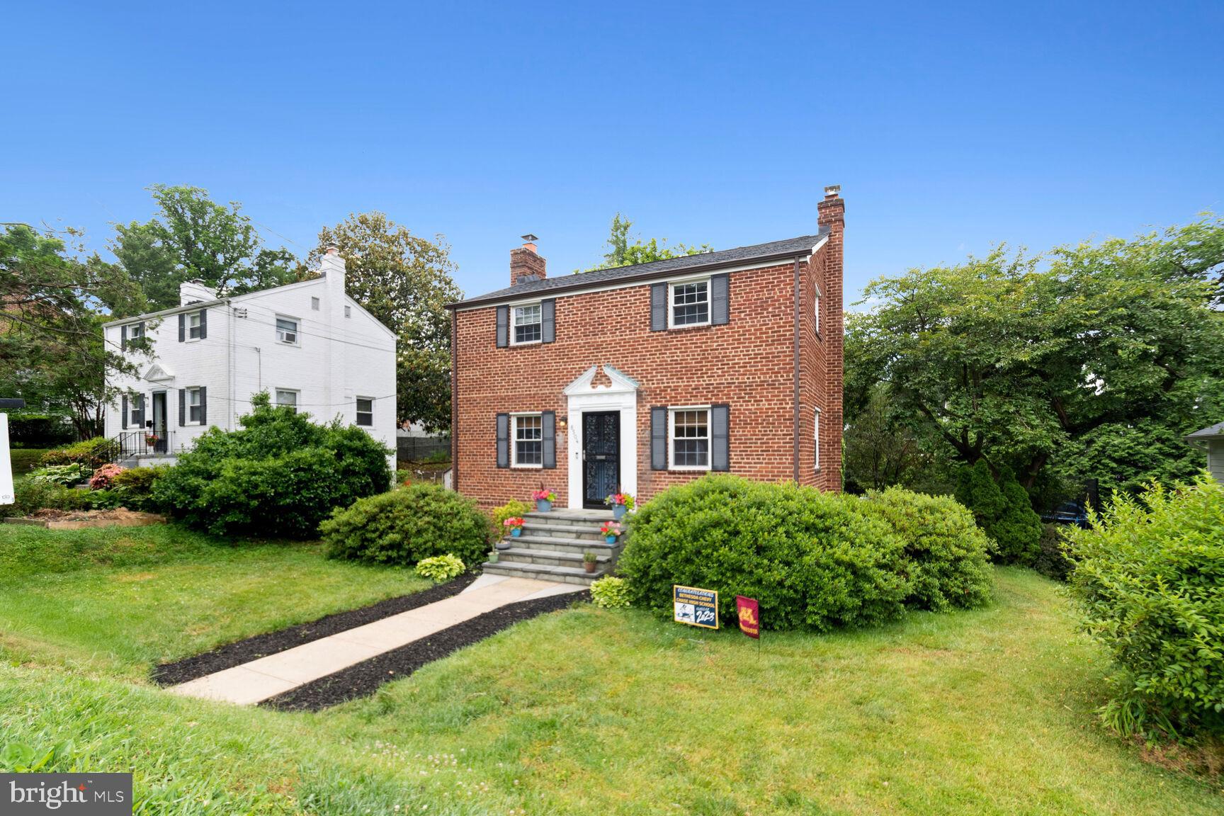 8504 Grubb Road Chevy Chase, MD 20815 - Photo 2 of 29 a front view of a house with a yard