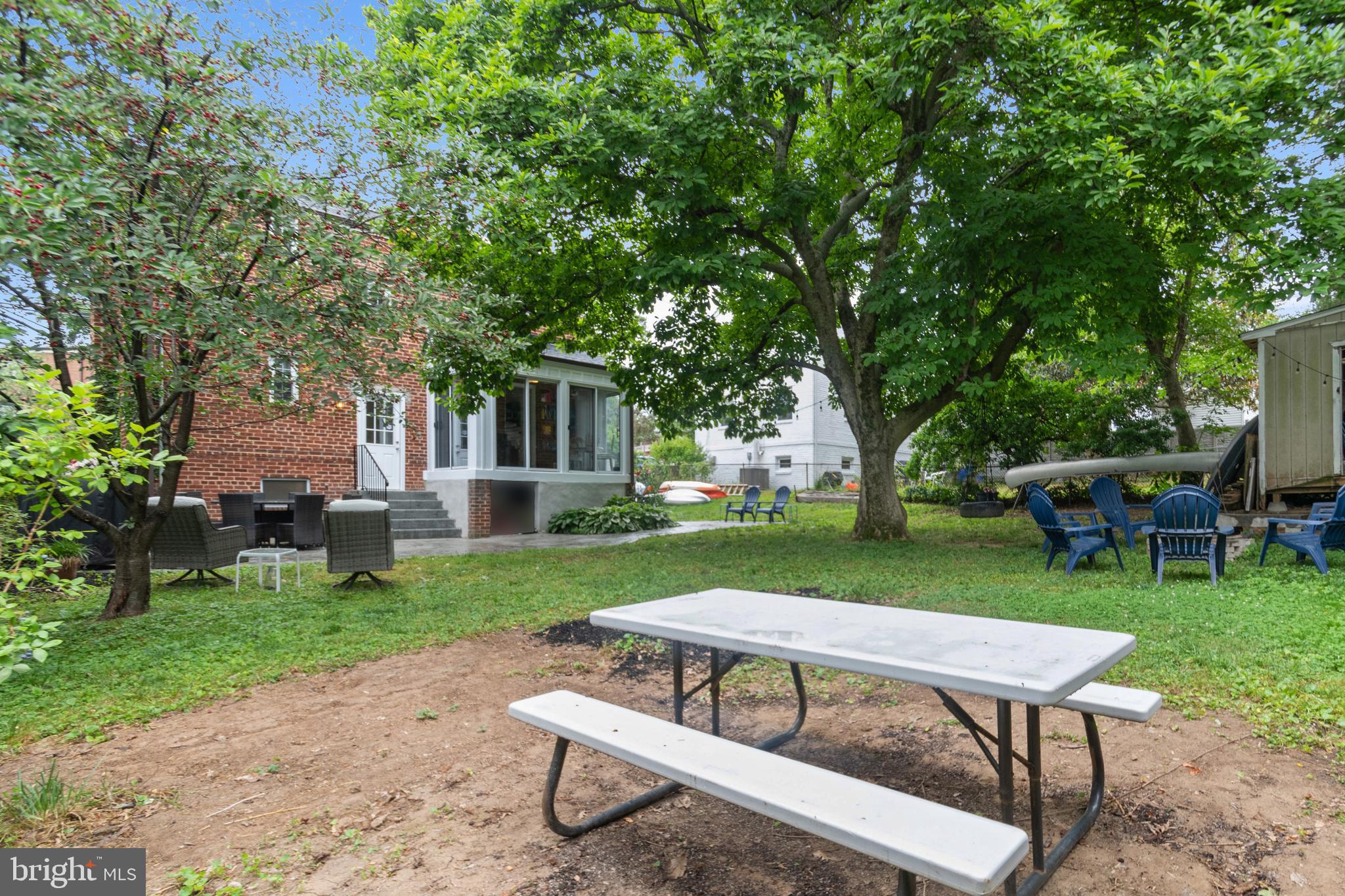 8504 Grubb Road Chevy Chase, MD 20815 - Photo 25 of 29 a view of a backyard with table and chairs with a table and chairs
