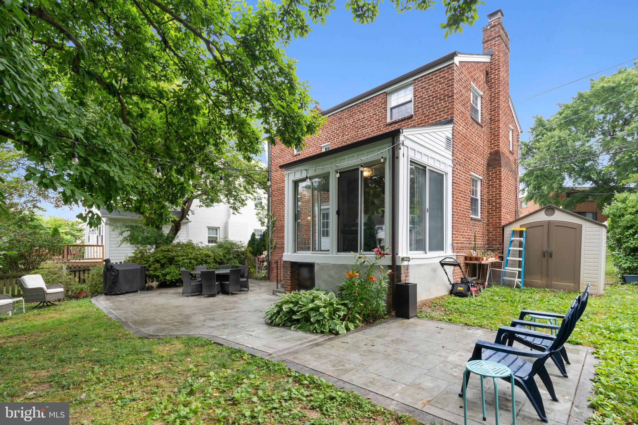 8504 Grubb Road Chevy Chase, MD 20815 - Photo 26 of 29 a view of a house with backyard sitting area and garden