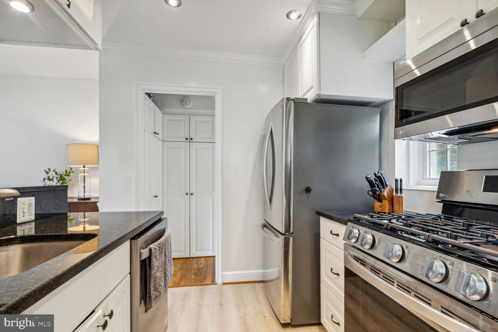 8504 Grubb Road Chevy Chase, MD 20815 - Photo 8 of 29 a kitchen with stainless steel appliances granite countertop a refrigerator and a stove