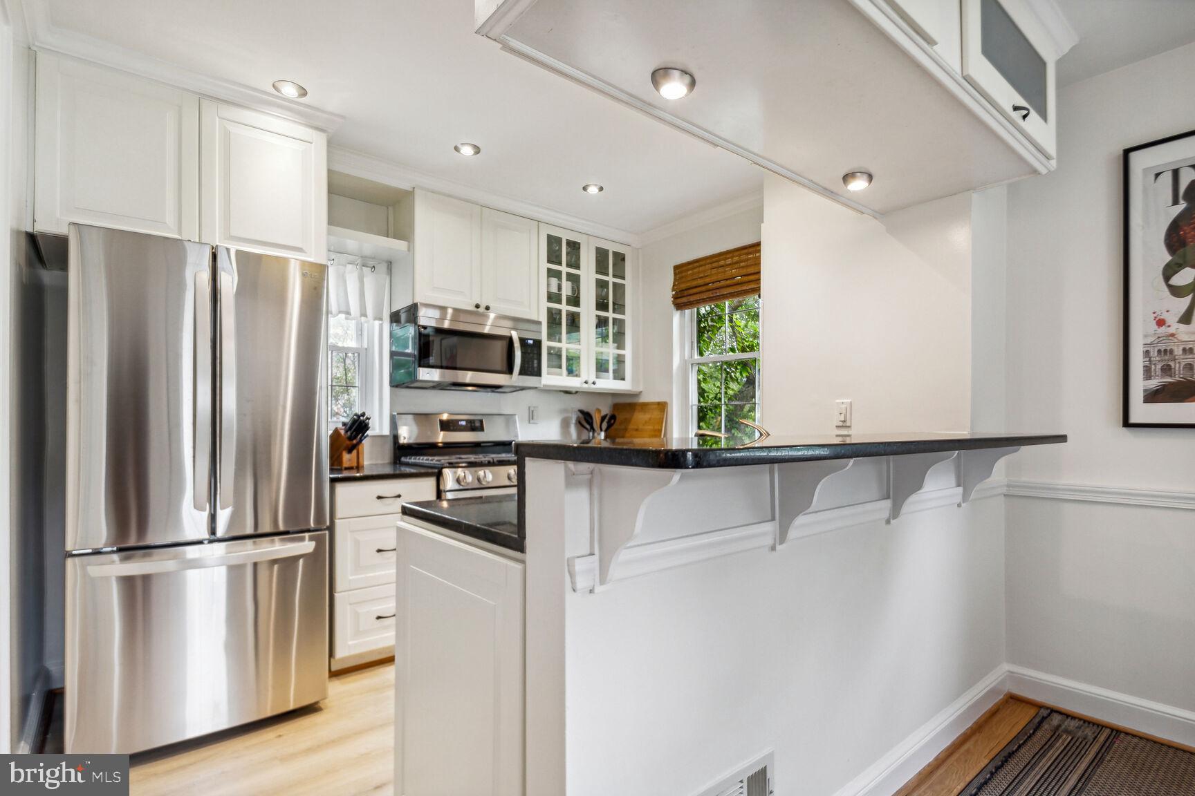 8504 Grubb Road Chevy Chase, MD 20815 - Photo 9 of 29 a kitchen with stainless steel appliances a refrigerator sink and microwave