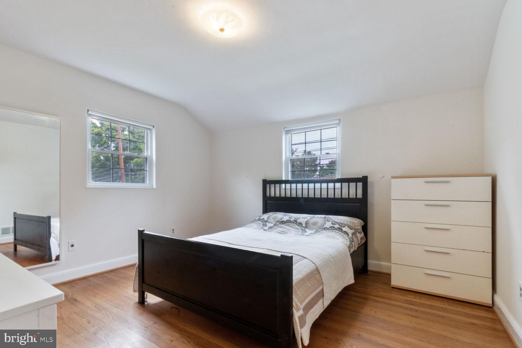 8504 Grubb Road Chevy Chase, MD 20815 - Photo 10 of 29 a bed sitting in a bedroom next to a window with a dresser