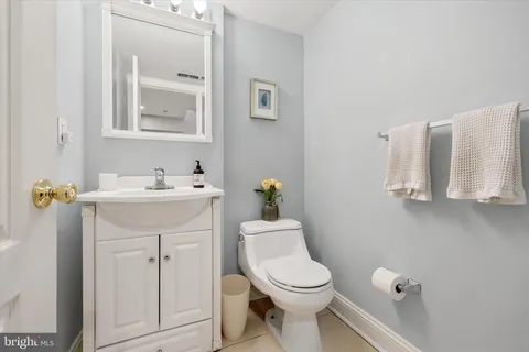 a bathroom with a sink a toilet and mirror