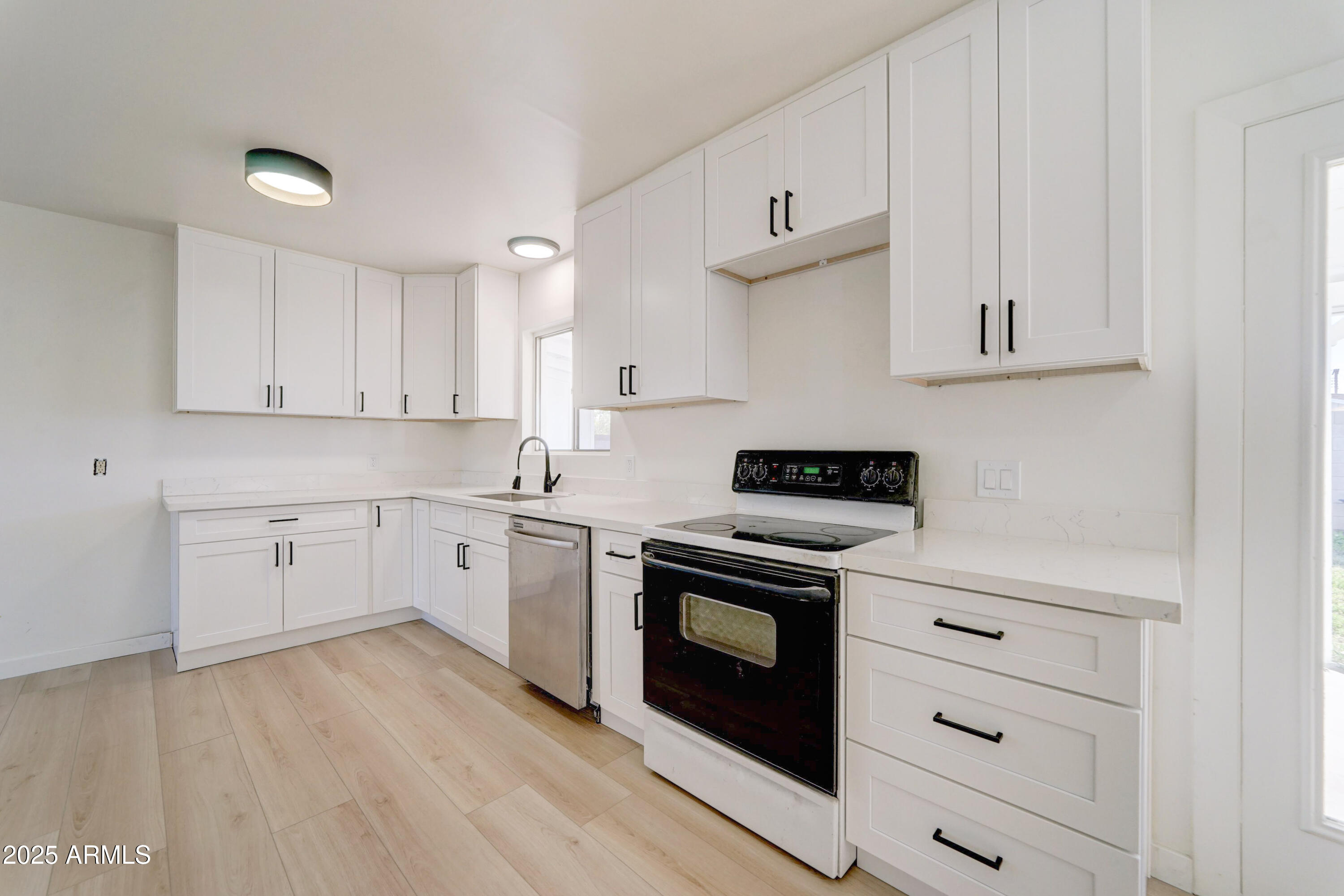 2039 West Northview Avenue Phoenix, AZ 85021 - Photo 11 of 30 a kitchen with granite countertop a stove top oven sink and cabinets