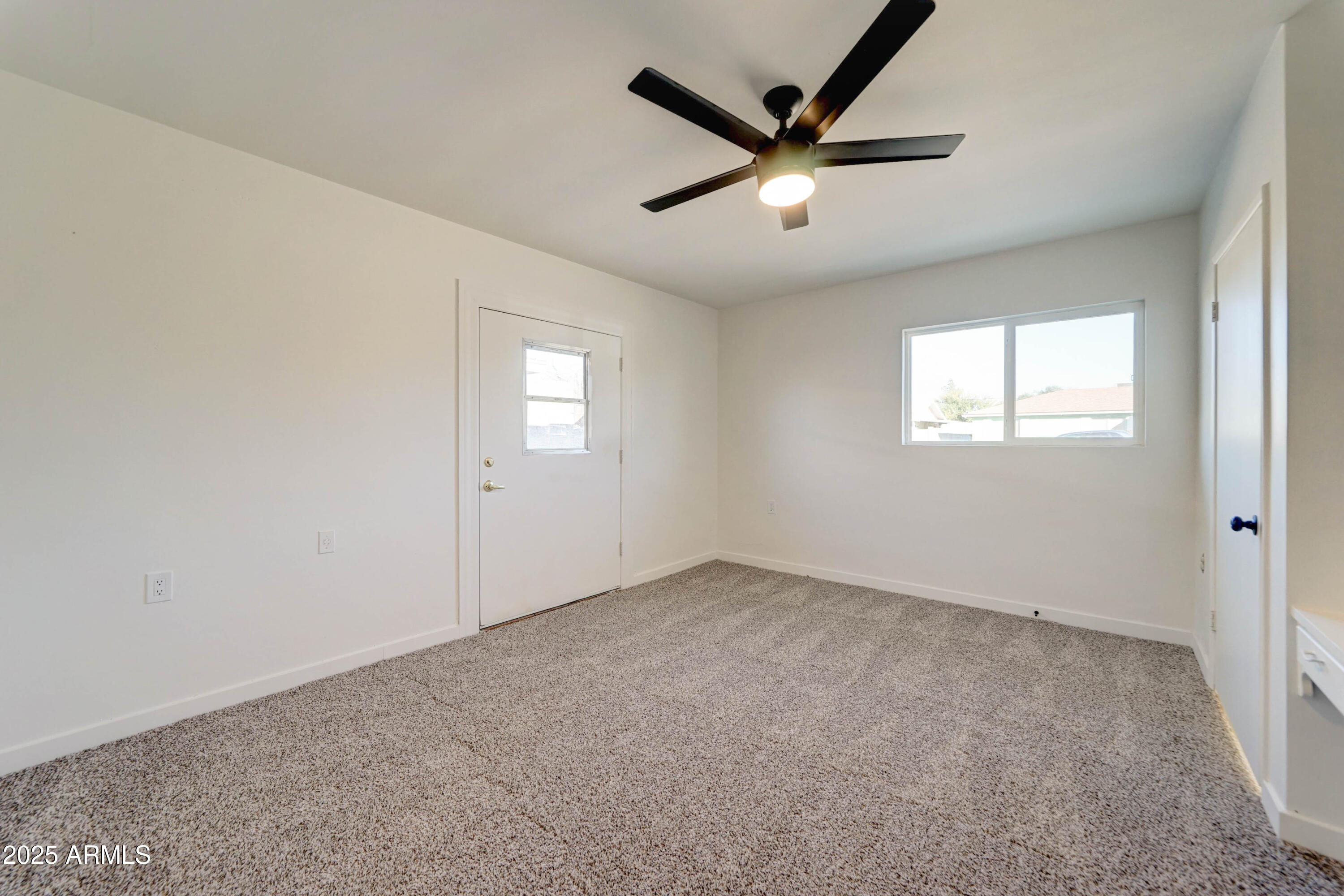 2039 West Northview Avenue Phoenix, AZ 85021 - Photo 15 of 30 an empty room with windows and fan