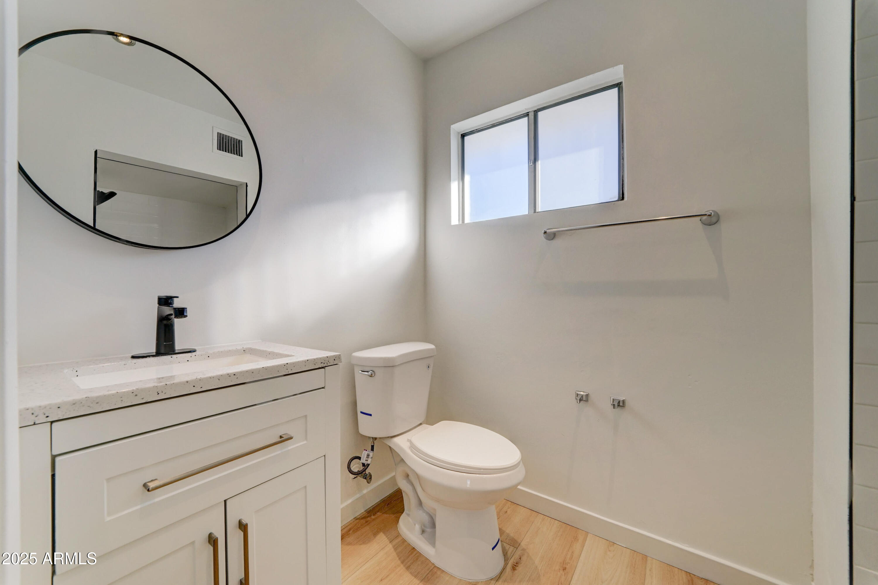 2039 West Northview Avenue Phoenix, AZ 85021 - Photo 18 of 30 a bathroom with a toilet a sink and mirror