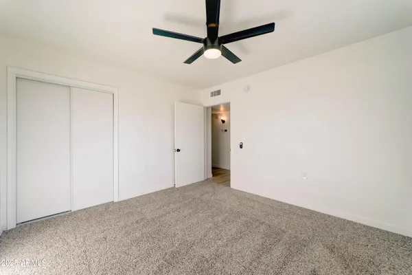 a view of a room with a ceiling fan