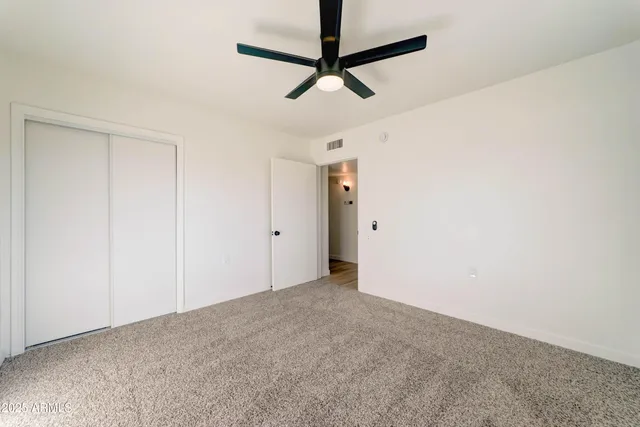 a view of a room with a ceiling fan