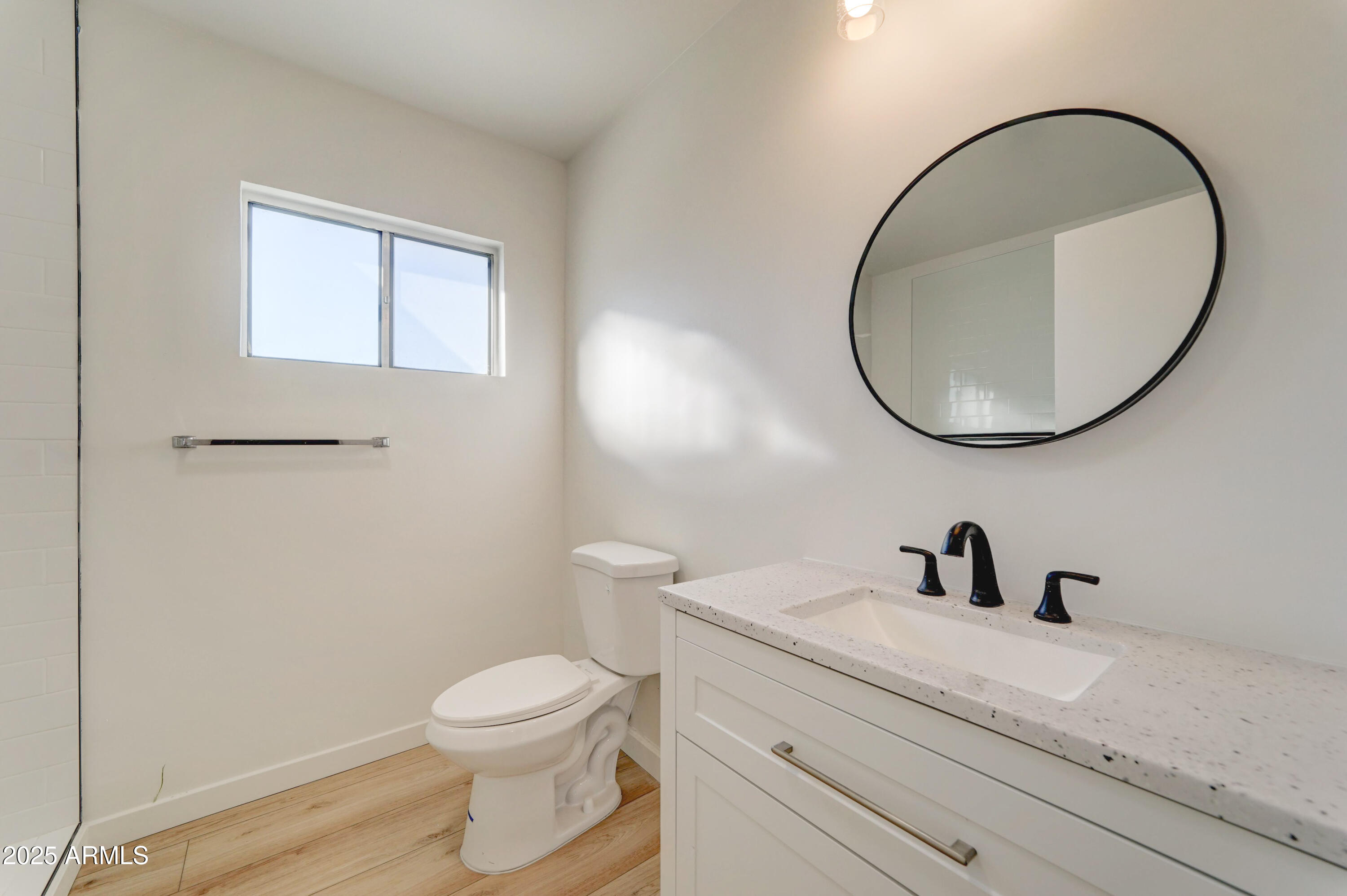 2039 West Northview Avenue Phoenix, AZ 85021 - Photo 24 of 30 a bathroom with a toilet a sink a mirror and vanity