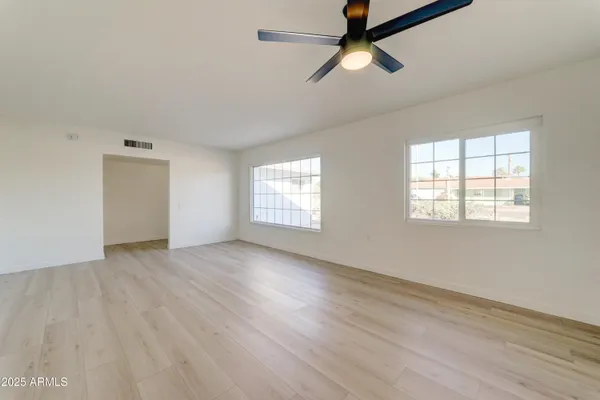 wooden floor in an empty room with a window