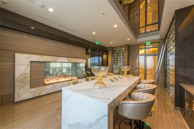 a dining room with stainless steel appliances granite countertop a sink and a large window