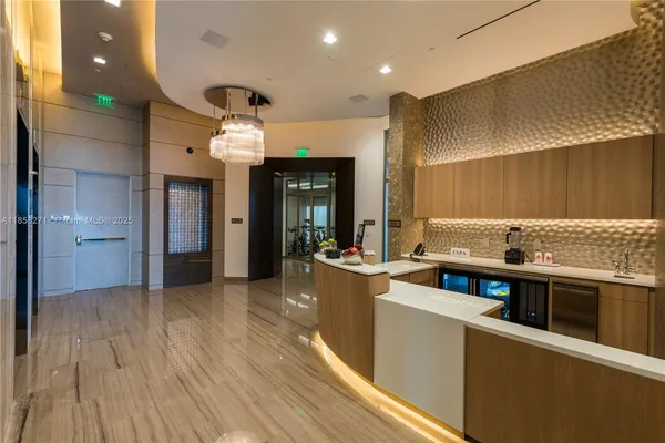 a kitchen with stainless steel appliances kitchen island granite countertop a stove and a wooden floors