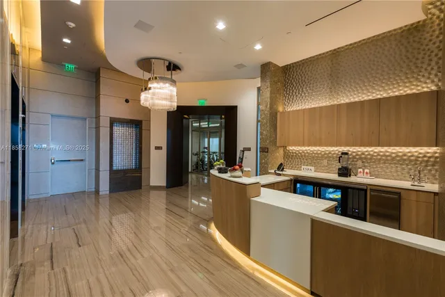 a kitchen with stainless steel appliances kitchen island granite countertop a stove and a wooden floors
