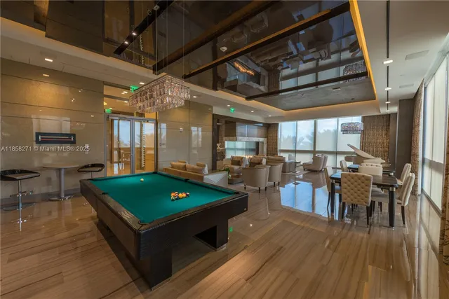 a living room with furniture a wooden floor and next to a window