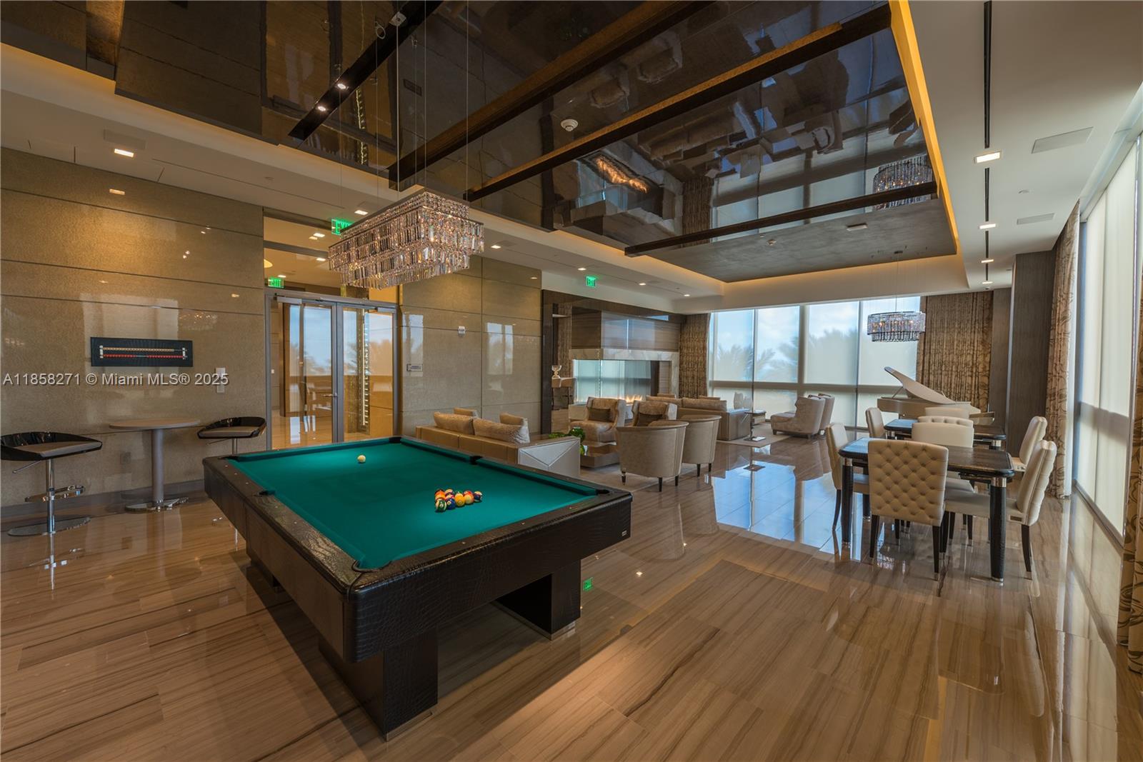 17749 Collins Avenue, Unit 802 Sunny Isles Beach, FL 33160 - Photo 10 of 25 a living room with furniture a wooden floor and next to a window