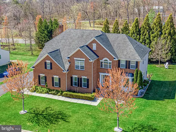 a aerial view of a house with a yard table and chairs