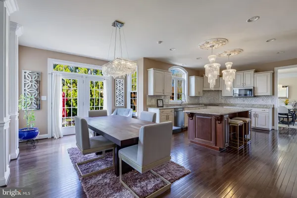 a kitchen with kitchen island granite countertop a sink a stove cabinets counter top space and stainless steel appliances