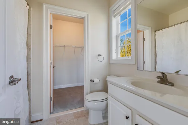 a bathroom with a granite countertop sink a large mirror and vanity