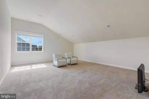a view of a room with wooden floor and chandelier