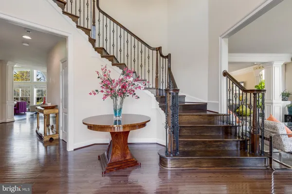 a view of entryway and hall with wooden floor