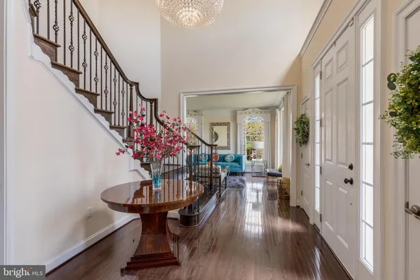 a view of entryway and hall with wooden floor