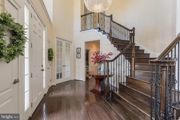 a view of entryway livingroom and hall with wooden floor