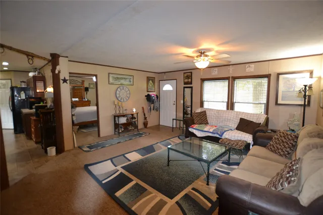 a living room with furniture a dining table and a chandelier