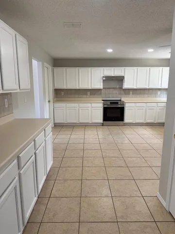 a kitchen with a cabinets and appliances
