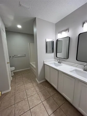 a bathroom with a double vanity sink and mirror