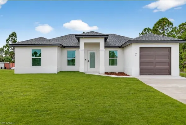 a front view of a house with a garden