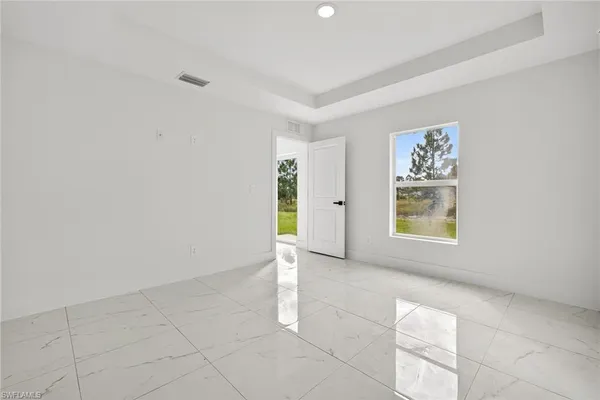 an empty room with windows and closet