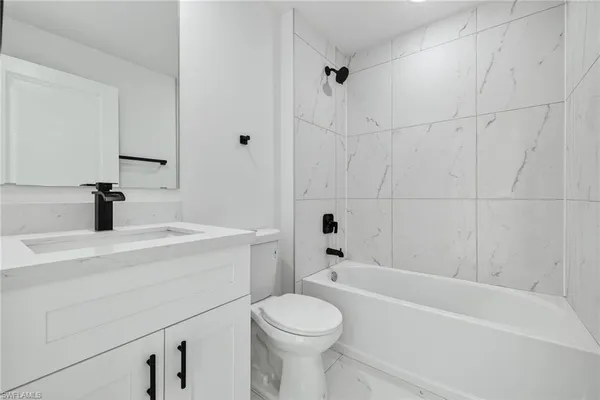 a bathroom with a sink a toilet and a bathtub