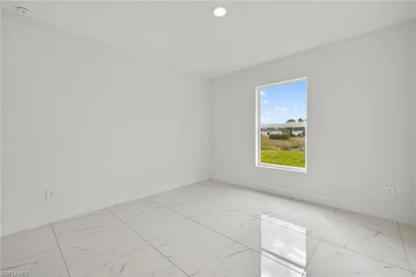 a view of an empty room and a window