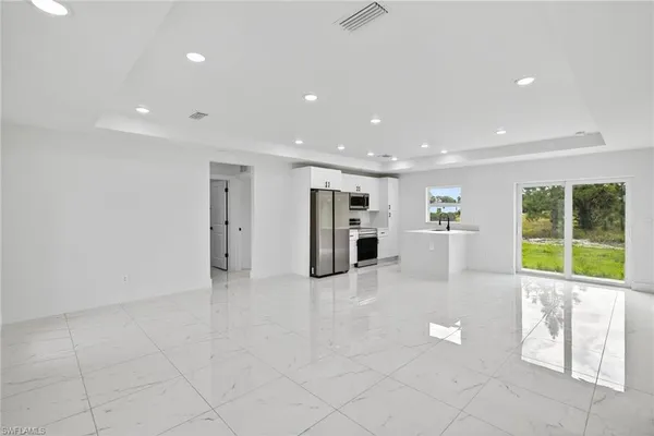 a view of kitchen with stainless steel appliances refrigerator and microwave