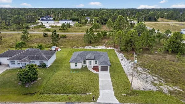 an aerial view of a house with a yard